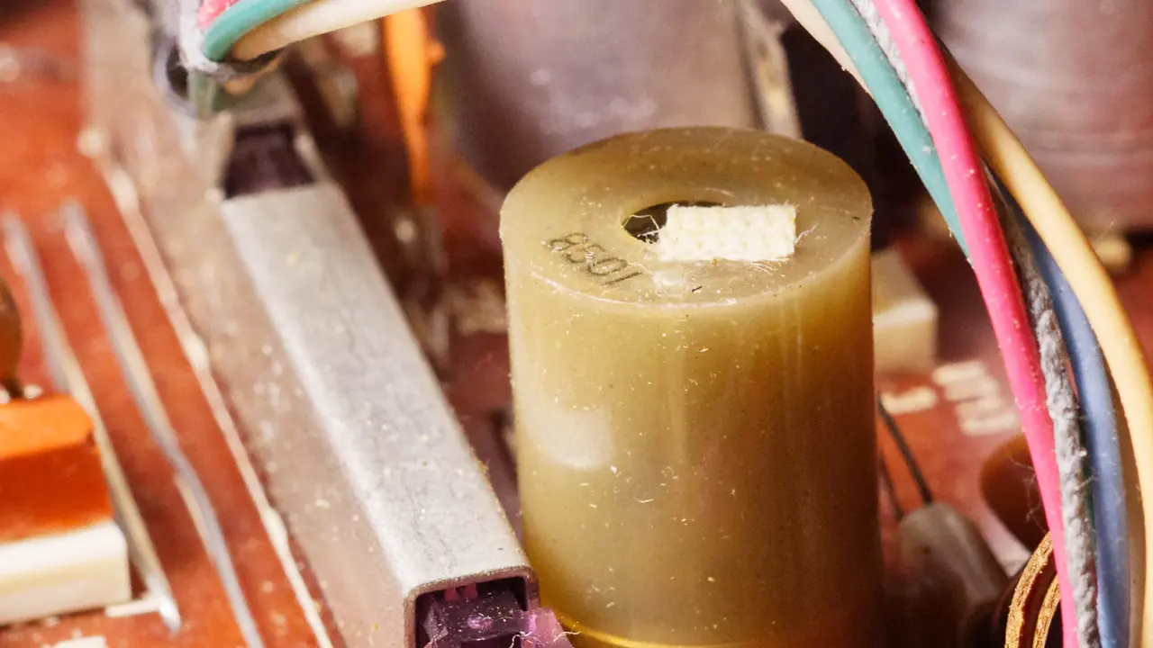 A wound inductor on a circuit board between coloured wires