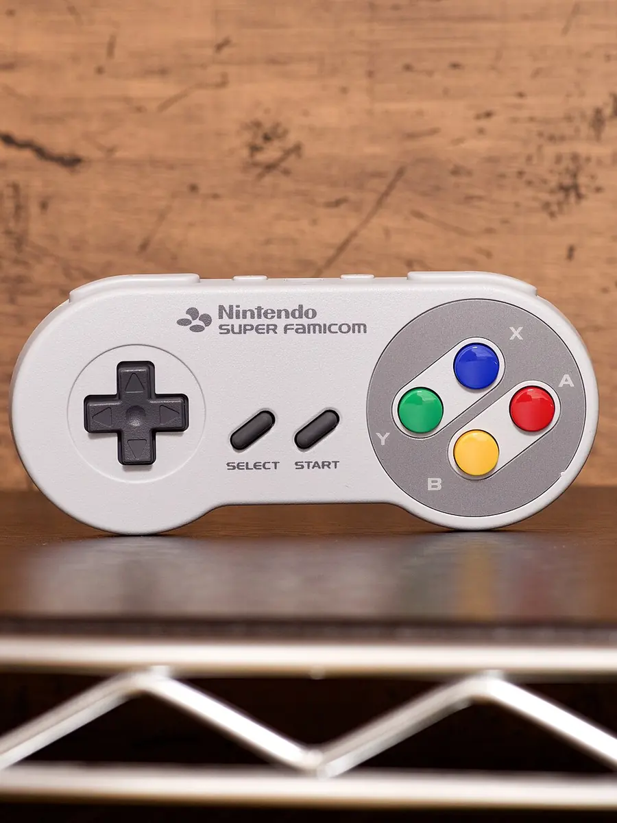 A Super Famicom controller resting on a wooden surface