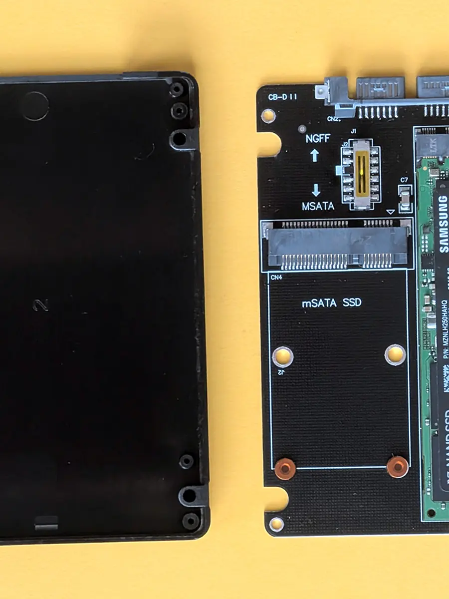 Two solid-state drives, one opened to show its board