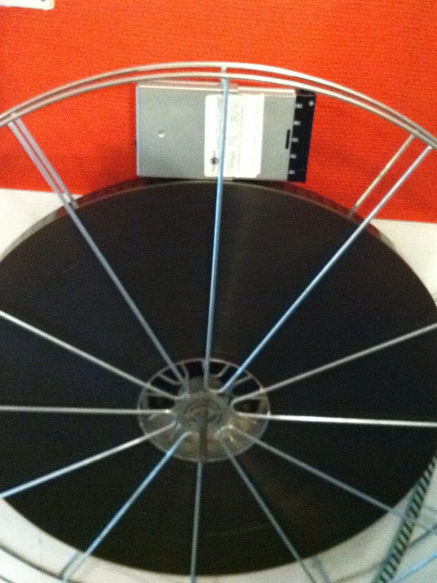 A 35 mm film spool beside a hard disk drive